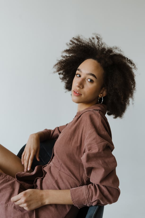 Woman in Brown Long Sleeve Dress Sitting