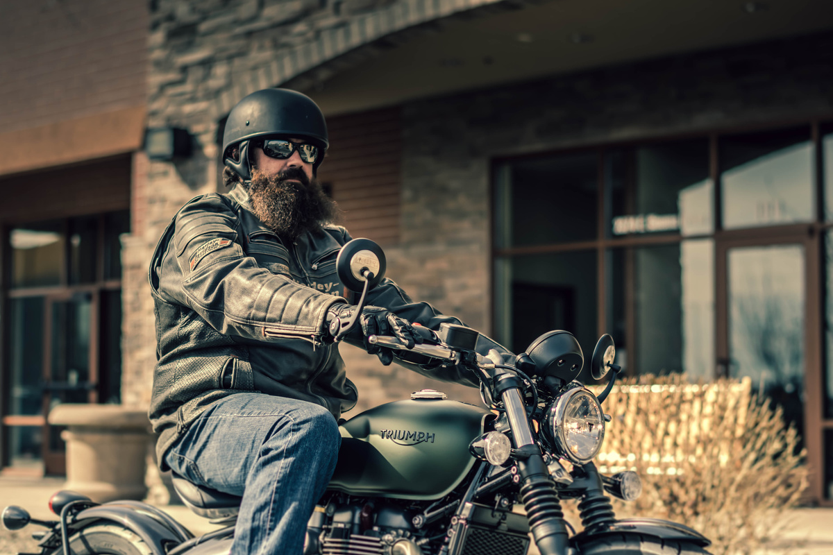 Selective Focus Photography Of man Riding Cafe Racer